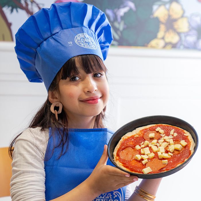 A child making pizza at PizzaExpress