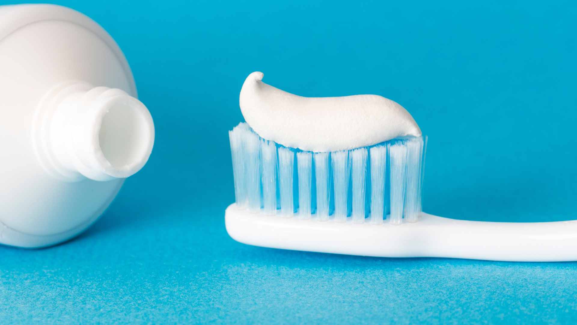 Different types of toothpaste on a toothbrush