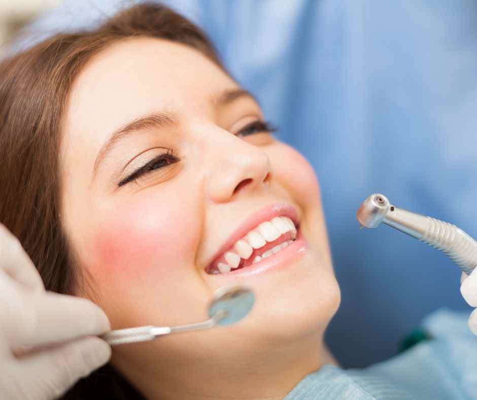 A woman smiling confidently, showing healthy white teeth
